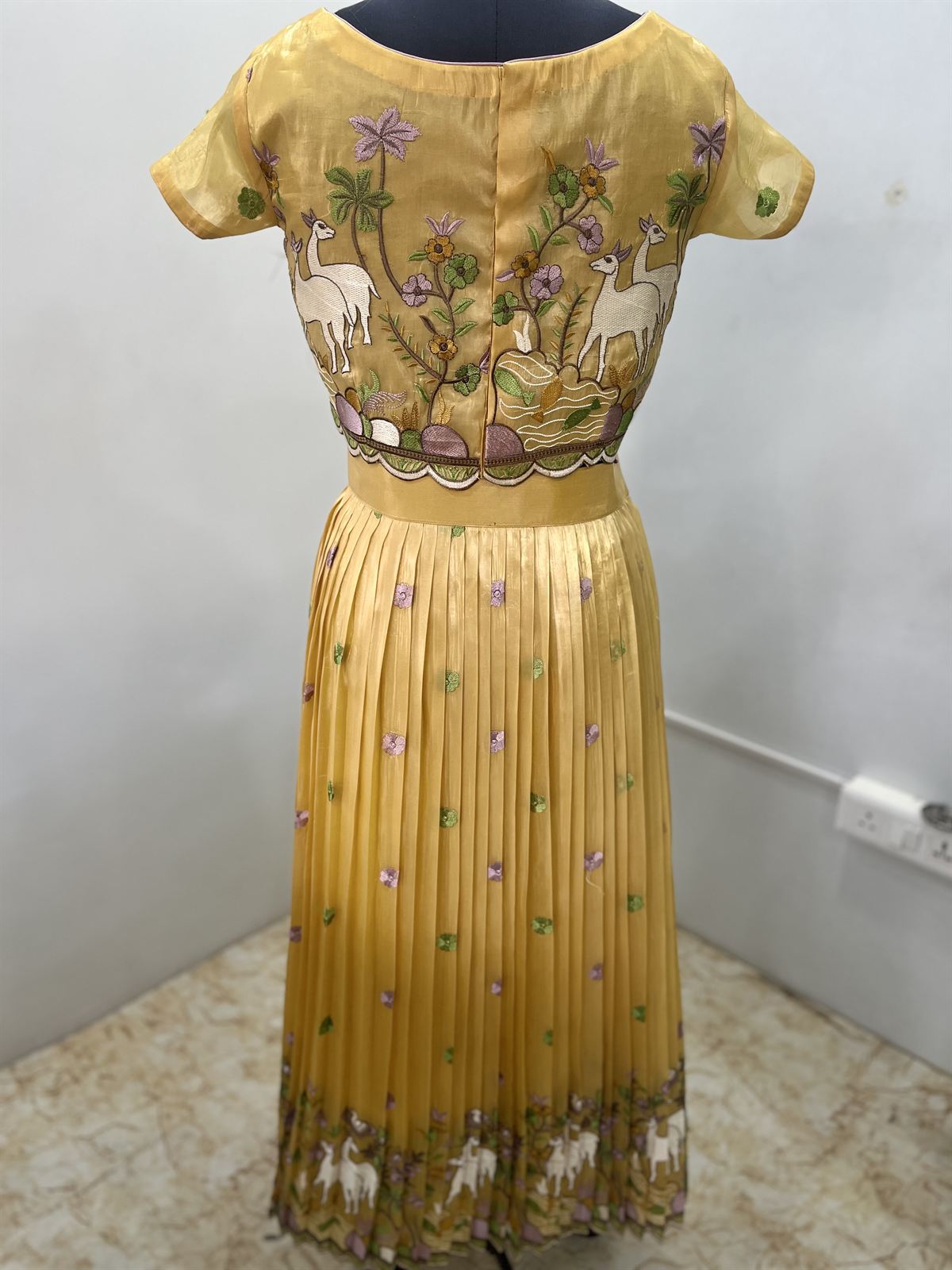 Mustard crop top and pleated skirt hand-painted in pichwai style with cows and lotus motifs