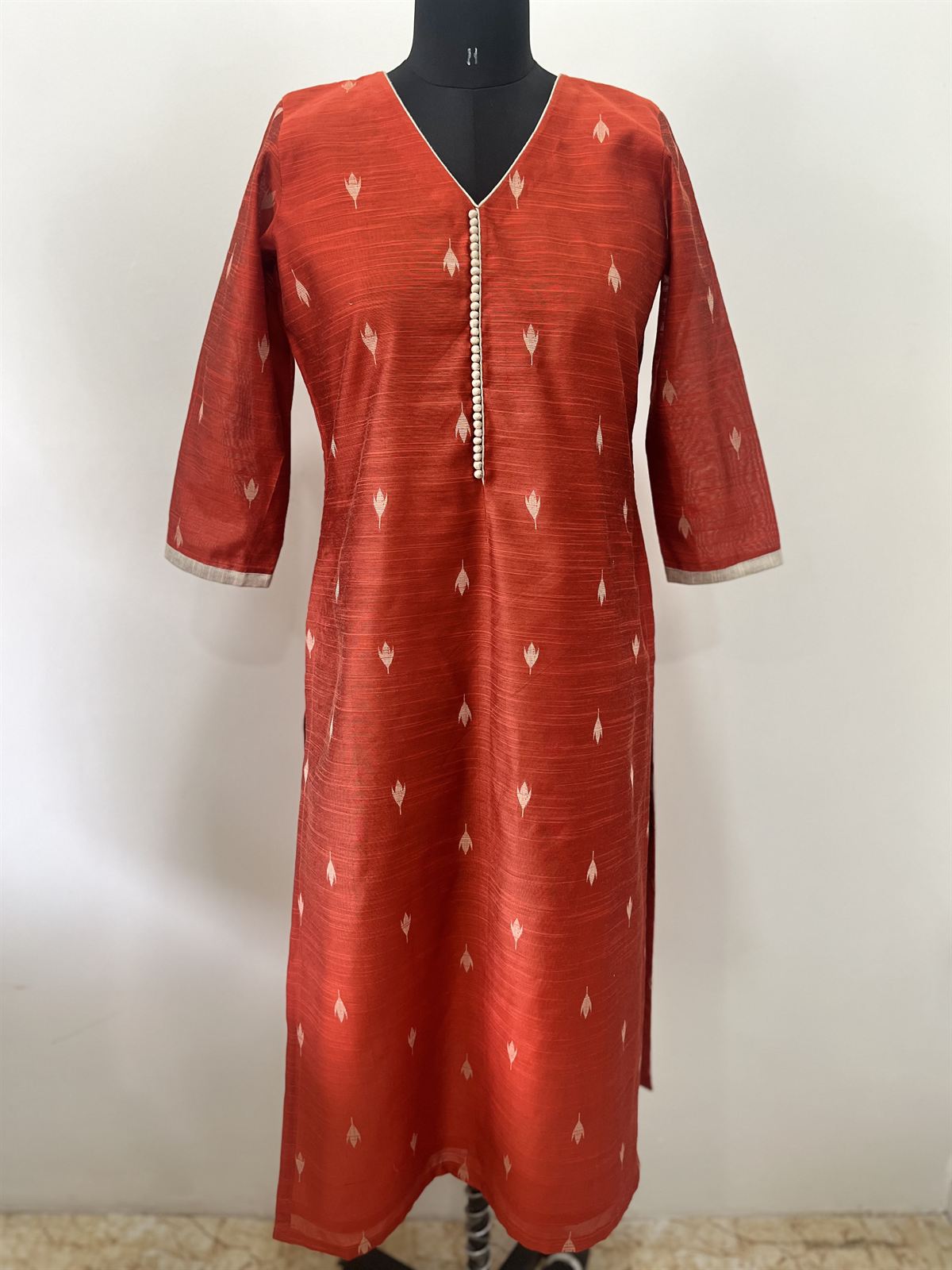Rust raw silk kurta with small woven motifs and a V-neck placket